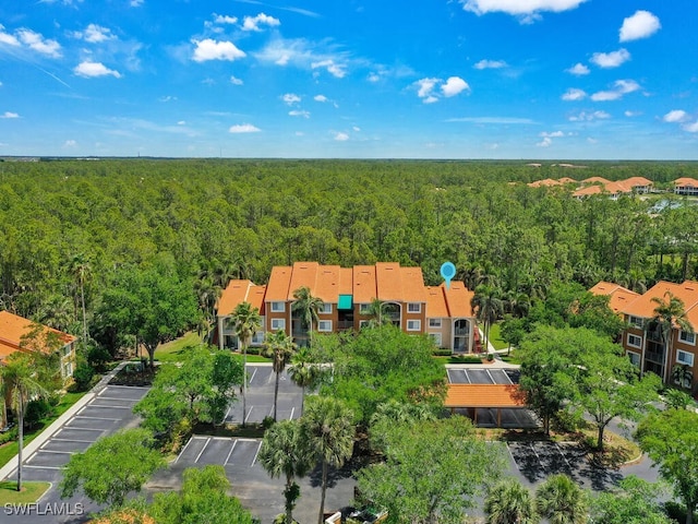 1180 Wildwood Lakes Blvd Unit 207, Naples, FL 34104 - aerial view featuring a view of trees