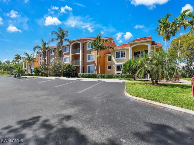 1180 Wildwood Lakes Blvd Unit 207, Naples, FL 34104 - view of building exterior with uncovered parking