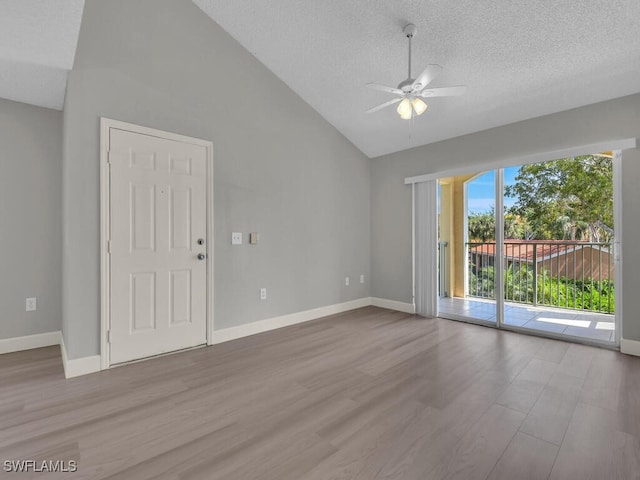 1180 Wildwood Lakes Blvd Unit 207, Naples, FL 34104 - spare room with ceiling fan, high vaulted ceiling, a textured ceiling, wood finished floors, and baseboards