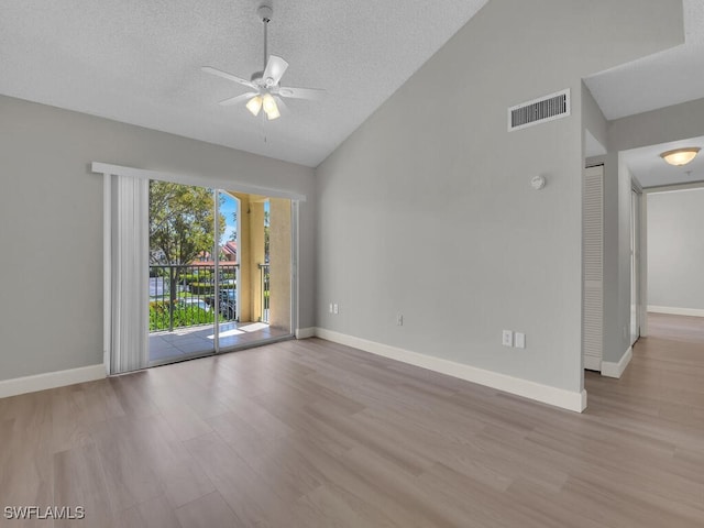 1180 Wildwood Lakes Blvd Unit 207, Naples, FL 34104 - unfurnished room featuring visible vents, ceiling fan, a textured ceiling, wood finished floors, and high vaulted ceiling