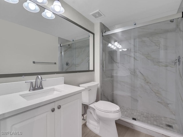 1180 Wildwood Lakes Blvd Unit 207, Naples, FL 34104 - full bathroom featuring a marble finish shower, visible vents, toilet, and vanity