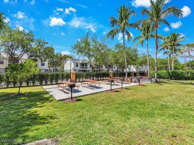 1180 Wildwood Lakes Blvd Unit 207, Naples, FL 34104 - view of property's community with fence, a residential view, and a lawn
