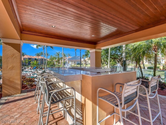1180 Wildwood Lakes Blvd Unit 207, Naples, FL 34104 - view of patio / terrace with fence and outdoor wet bar