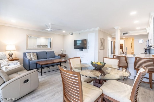 10 Tampa Pl Unit 401, Marco Island, FL 34145 - dining space with ornamental molding, visible vents, light wood-style flooring, and ceiling fan