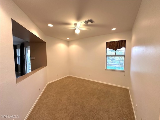 8091 Allamanda Ct, Lehigh Acres, FL 33972 - spare room with carpet floors, baseboards, visible vents, and ceiling fan