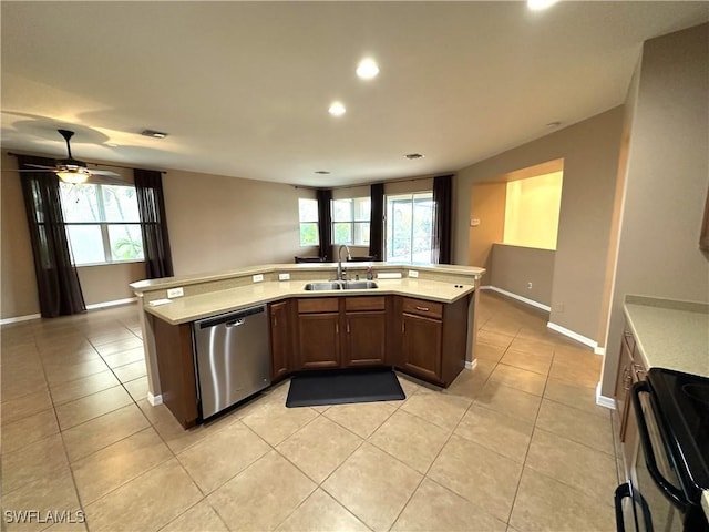 8091 Allamanda Ct, Lehigh Acres, FL 33972 - kitchen featuring light countertops, range, stainless steel dishwasher, a sink, and light tile patterned flooring