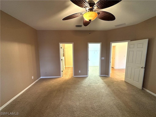 8091 Allamanda Ct, Lehigh Acres, FL 33972 - interior space with a spacious closet, baseboards, ceiling fan, visible vents, and light carpet