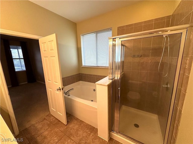 8091 Allamanda Ct, Lehigh Acres, FL 33972 - bathroom featuring a stall shower, tile patterned floors, and a bath