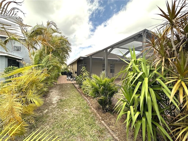8091 Allamanda Ct, Lehigh Acres, FL 33972 - view of yard featuring a patio and a lanai