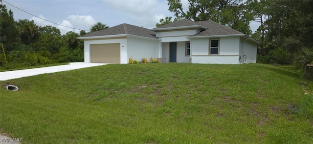 5005 Eifel Ln, Labelle, FL 33935 - prairie-style home with concrete driveway, an attached garage, a front lawn, and stucco siding