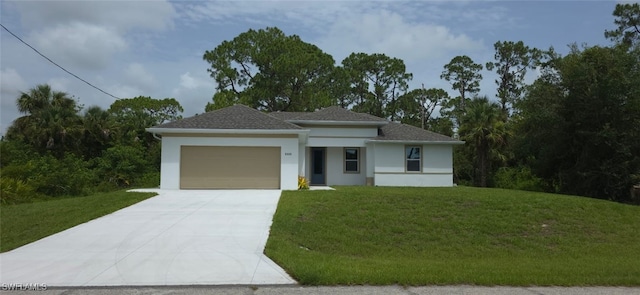 5005 Eifel Ln, Labelle, FL 33935 - prairie-style house with a garage, concrete driveway, stucco siding, and a front lawn