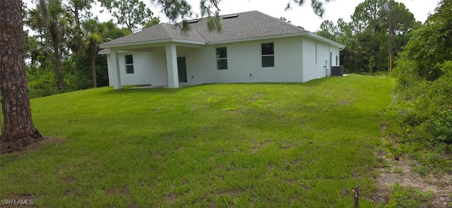 5005 Eifel Ln, Labelle, FL 33935 - back of property featuring stucco siding, a lawn, and a shingled roof