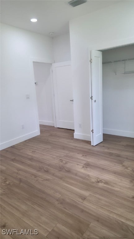 5005 Eifel Ln, Labelle, FL 33935 - unfurnished bedroom featuring wood finished floors, recessed lighting, and a closet