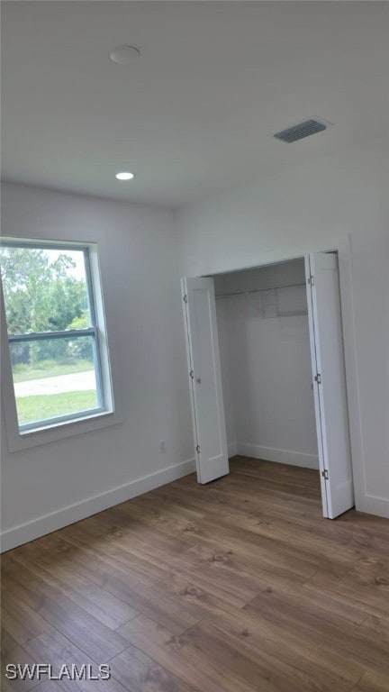 5005 Eifel Ln, Labelle, FL 33935 - unfurnished bedroom with wood finished floors, recessed lighting, and a closet
