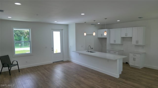 5005 Eifel Ln, Labelle, FL 33935 - kitchen with a peninsula, white cabinetry, recessed lighting, dark wood-type flooring, and decorative light fixtures