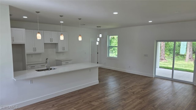 5005 Eifel Ln, Labelle, FL 33935 - kitchen with dark wood finished floors, white cabinets, recessed lighting, light countertops, and hanging light fixtures