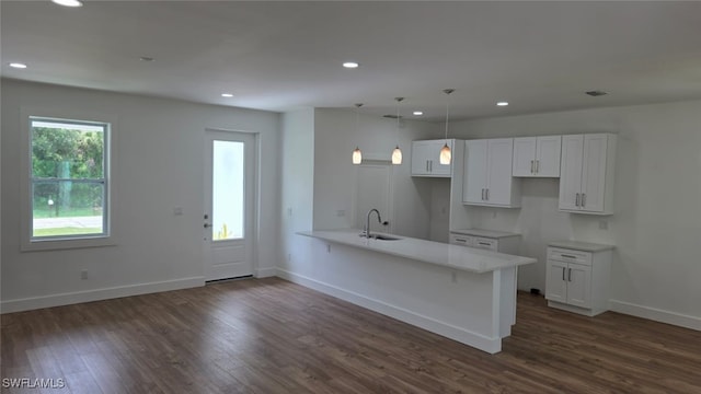 5005 Eifel Ln, Labelle, FL 33935 - kitchen featuring a peninsula, dark wood finished floors, white cabinets, recessed lighting, and decorative light fixtures