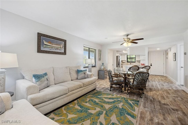 4967 Pepper Cir Unit 206, Naples, FL 34113 - living room with wood finished floors, a ceiling fan, and baseboards