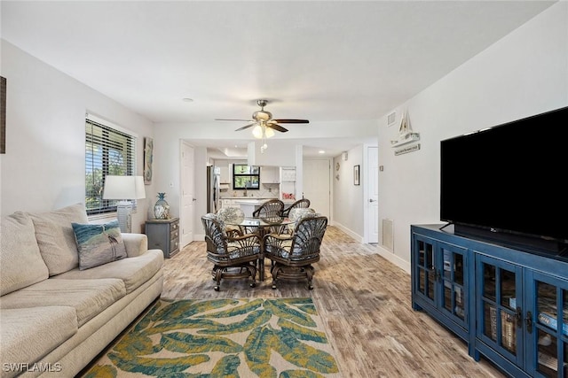 4967 Pepper Cir Unit 206, Naples, FL 34113 - living room with wood finished floors, a ceiling fan, healthy amount of natural light, and baseboards