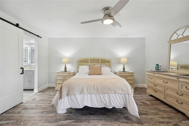 4967 Pepper Cir Unit 206, Naples, FL 34113 - bedroom featuring a barn door, wood finished floors, and baseboards