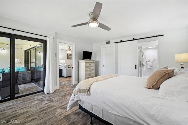 4967 Pepper Cir Unit 206, Naples, FL 34113 - bedroom with a barn door, access to exterior, wood finished floors, ceiling fan, and baseboards