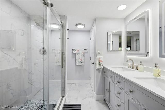 4967 Pepper Cir Unit 206, Naples, FL 34113 - bathroom with marble look tiles, a marble finish shower, baseboards, and double vanity