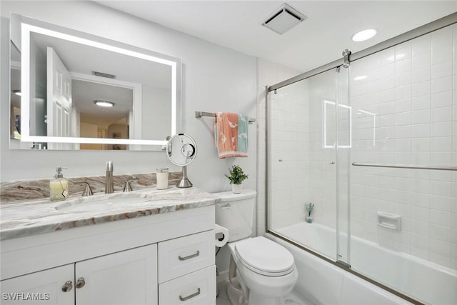 4967 Pepper Cir Unit 206, Naples, FL 34113 - full bathroom featuring vanity, toilet, and enclosed tub / shower combo