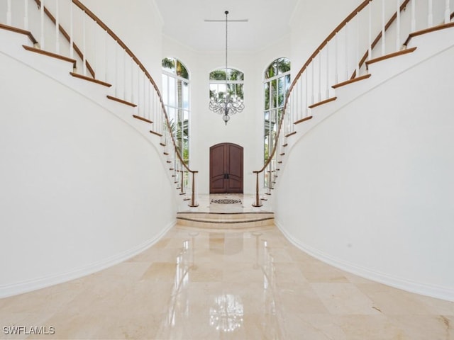 4244 Brynwood Dr, Naples, FL 34119 - foyer entrance with a high ceiling, marble finish floor, baseboards, and stairs