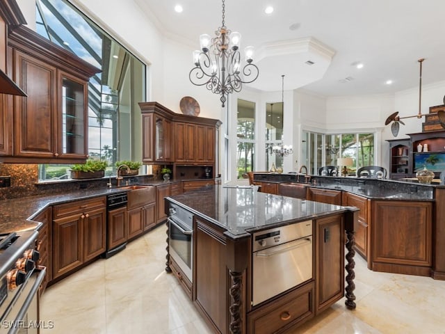 4244 Brynwood Dr, Naples, FL 34119 - kitchen with crown molding, stainless steel appliances, a center island, and a notable chandelier
