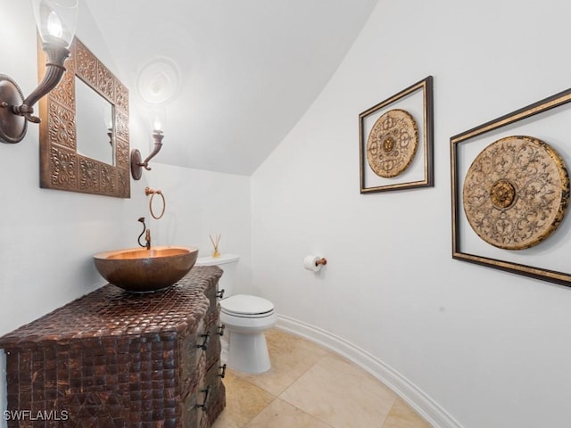 4244 Brynwood Dr, Naples, FL 34119 - bathroom with toilet, vanity, lofted ceiling, tile patterned flooring, and baseboards