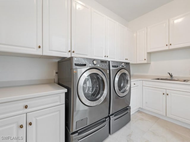 4244 Brynwood Dr, Naples, FL 34119 - clothes washing area featuring marble finish floor, washing machine and clothes dryer, a sink, and cabinet space