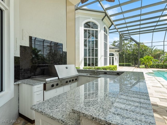 4244 Brynwood Dr, Naples, FL 34119 - view of patio with a sink, area for grilling, a lanai, and an outdoor pool
