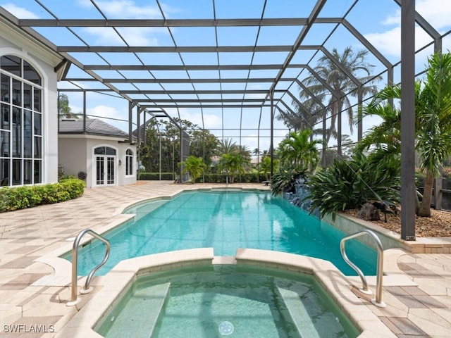 4244 Brynwood Dr, Naples, FL 34119 - view of pool featuring a pool with connected hot tub, a lanai, a patio, and french doors