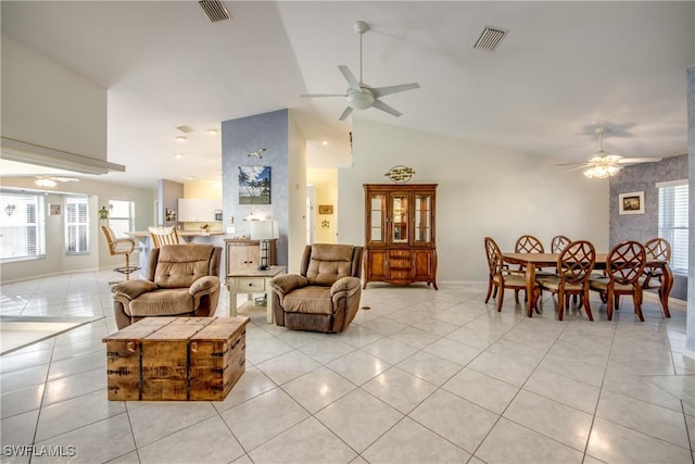 living room with visible vents, light tile patterned flooring, and ceiling fan