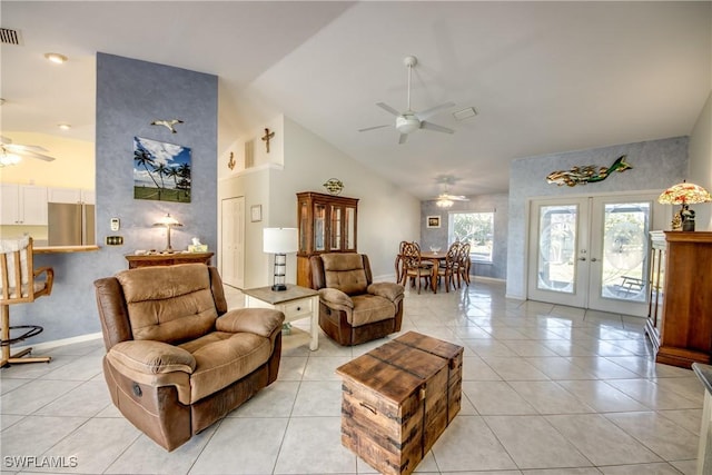 living area with light tile patterned flooring, high vaulted ceiling, french doors, a ceiling fan, and visible vents