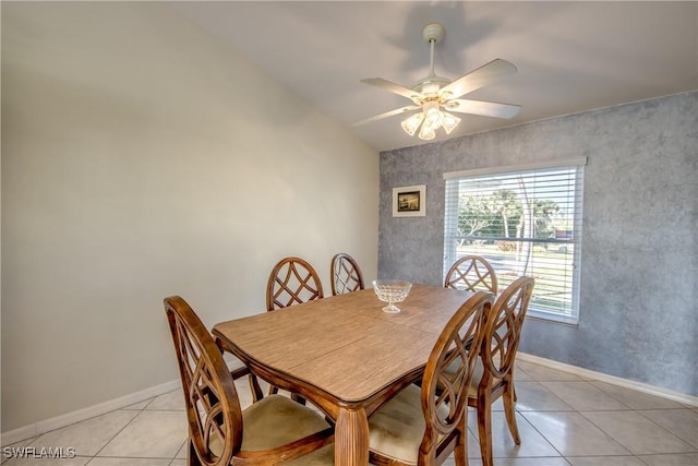 dining space featuring a ceiling fan, light tile patterned flooring, and baseboards