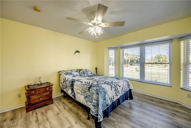 bedroom featuring baseboards and wood finished floors