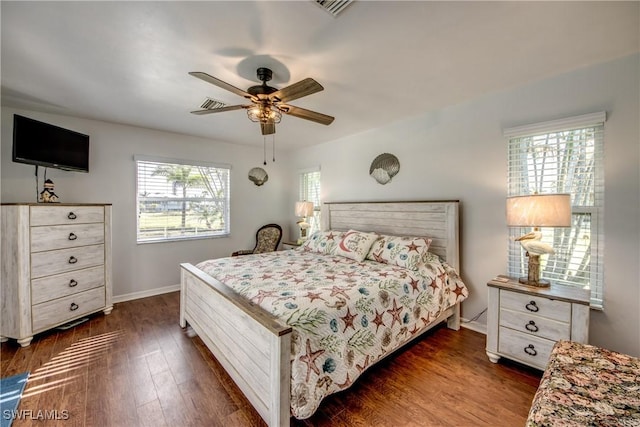 bedroom with dark wood finished floors, baseboards, visible vents, and ceiling fan