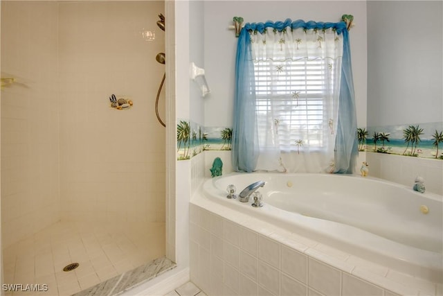 bathroom featuring a tile shower and a bath