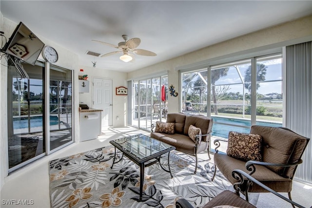 living room featuring visible vents and a ceiling fan
