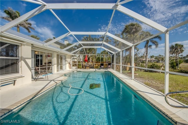 pool featuring a patio and glass enclosure