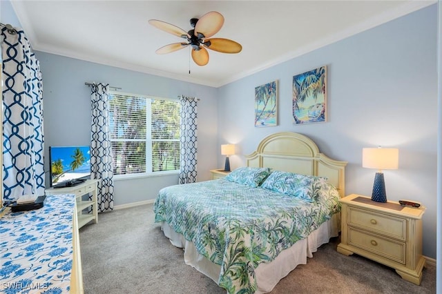carpeted bedroom with ornamental molding, baseboards, and ceiling fan