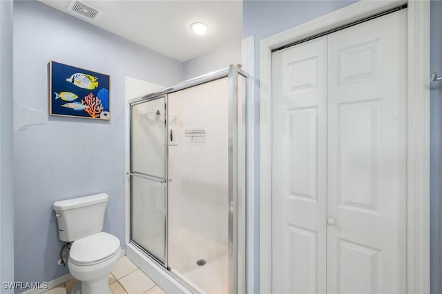 bathroom with tile patterned floors, a closet, toilet, a shower stall, and visible vents