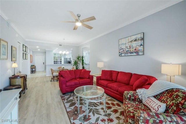 living area featuring ceiling fan with notable chandelier, visible vents, crown molding, and wood finished floors