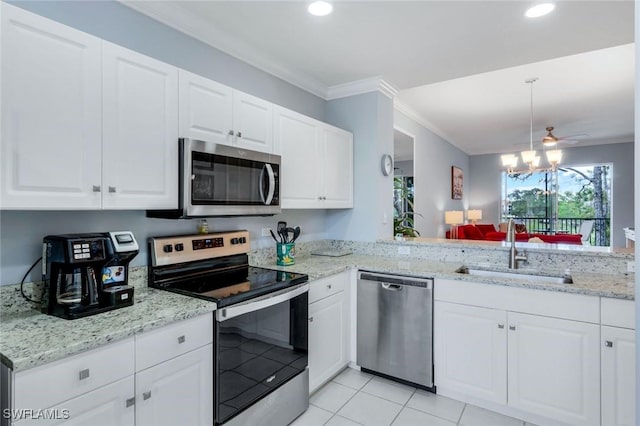 kitchen featuring ornamental molding, a sink, stainless steel appliances, and light stone countertops