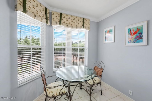dining area featuring baseboards, crown molding, and tile patterned flooring