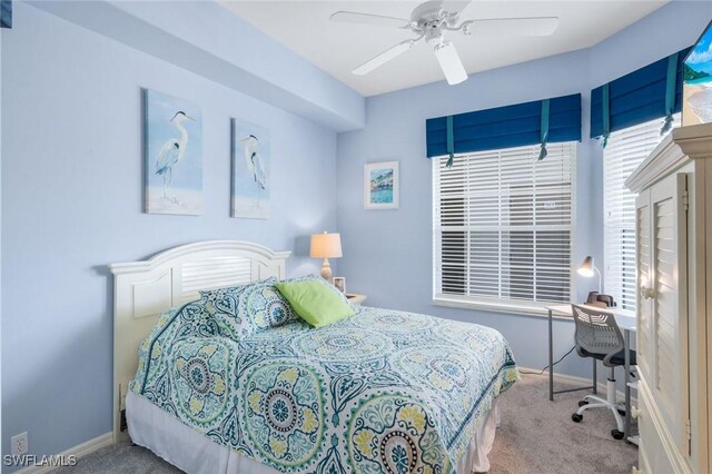 bedroom with baseboards, carpet floors, and a ceiling fan