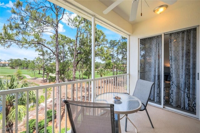 balcony featuring outdoor dining area and a ceiling fan