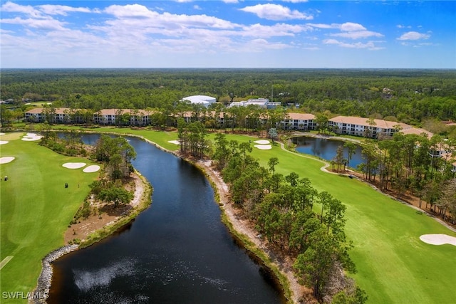 birds eye view of property with view of golf course, a water view, and a view of trees