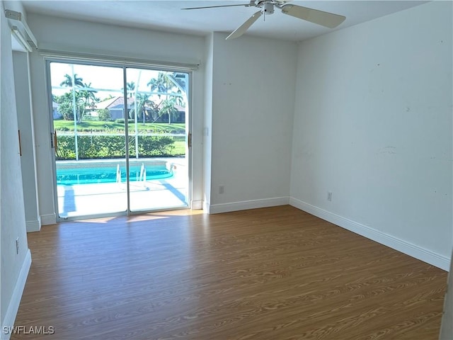 4830 Shearwater Ln, Naples, FL 34119 - spare room with baseboards, dark wood-style flooring, and ceiling fan